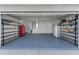 Spacious garage with ample storage shelves, a red tool chest, and clean epoxy floors at 906 Highland Crest Cir, Lake Wales, FL 33853