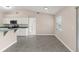 Bright eat-in kitchen featuring white cabinetry, stainless steel appliances and a breakfast bar at 906 Highland Crest Cir, Lake Wales, FL 33853