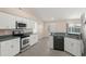 Bright kitchen includes stainless steel appliances, tile floors, and a breakfast bar at 906 Highland Crest Cir, Lake Wales, FL 33853