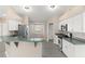 Well-lit kitchen features white cabinets, stainless steel appliances, and a breakfast bar at 906 Highland Crest Cir, Lake Wales, FL 33853