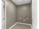 Clean and functional laundry room with neutral walls at 906 Highland Crest Cir, Lake Wales, FL 33853
