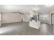 Open-concept living space with a breakfast bar connecting the living area to the kitchen at 906 Highland Crest Cir, Lake Wales, FL 33853