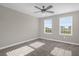 Bright bedroom with neutral walls, carpet, ceiling fan, and two windows at 9535 Beautiful Way, Winter Garden, FL 34787