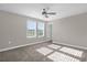 This bright carpeted bedroom has a ceiling fan and windows with bright sunlight at 9535 Beautiful Way, Winter Garden, FL 34787