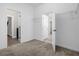 A carpeted bedroom with a closet and entryways into other rooms is bright and welcoming at 9535 Beautiful Way, Winter Garden, FL 34787