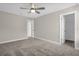 Carpeted bedroom includes a ceiling fan, ensuite bathroom, and closet at 9535 Beautiful Way, Winter Garden, FL 34787