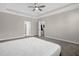 Main bedroom with tray ceiling, neutral paint, carpet and doorway to ensuite bathroom at 9535 Beautiful Way, Winter Garden, FL 34787