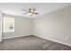 Bright carpeted bedroom features a ceiling fan and sun-filled window at 9535 Beautiful Way, Winter Garden, FL 34787