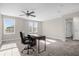 A large bonus room with carpet features a ceiling fan and a work desk area at 9535 Beautiful Way, Winter Garden, FL 34787