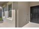 Inviting entrance with a classic black front door and neutral-toned exterior at 9535 Beautiful Way, Winter Garden, FL 34787