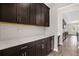 Stylish kitchen with dark cabinets, quartz countertops, and subway tile backsplash at 9535 Beautiful Way, Winter Garden, FL 34787