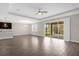 Large living room offers tile floors, tray ceilings, fan and opens to screened lanai at 9535 Beautiful Way, Winter Garden, FL 34787