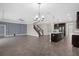 Open-concept living area shows staircase, tile floors, fan, and modern kitchen with island at 9535 Beautiful Way, Winter Garden, FL 34787