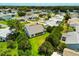 Aerial view of the property showcasing its well-manicured lawn, landscaping, and neighborhood at 956 Chula Ct, Lady Lake, FL 32159