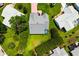 An aerial view of a well-maintained property, highlighting its mature landscaping and manicured lawns at 956 Chula Ct, Lady Lake, FL 32159
