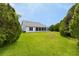 A well-maintained backyard with manicured lawn and a view of the home's rear facade at 956 Chula Ct, Lady Lake, FL 32159