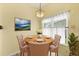 Cozy dining area with a round table, four chairs, and natural light, perfect for intimate meals at 956 Chula Ct, Lady Lake, FL 32159