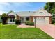 Charming single-story home featuring a well-maintained front lawn and a two-car garage at 956 Chula Ct, Lady Lake, FL 32159