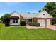 Charming brick and siding home with a well-manicured lawn and a covered entrance, showcasing curb appeal at 956 Chula Ct, Lady Lake, FL 32159