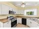 Functional kitchen featuring white cabinetry, modern appliances, and ample counter space for culinary enthusiasts at 956 Chula Ct, Lady Lake, FL 32159