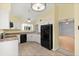 Bright kitchen with white cabinets and black appliances, offering plenty of space for cooking and storage at 956 Chula Ct, Lady Lake, FL 32159