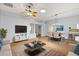 Bright, spacious living room with modern furnishings, a ceiling fan, and a seamless open-concept design at 956 Chula Ct, Lady Lake, FL 32159