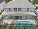 Aerial view of the home's backyard featuring a screen-enclosed in-ground pool and lanai at 10319 Lavande Dr, Orlando, FL 32836