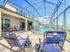 Enjoy the comfort of outdoor seating near a sparkling in-ground pool within a screened lanai at 10319 Lavande Dr, Orlando, FL 32836