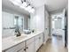 Bathroom with double sink vanity with granite countertop, large mirror, and tile floor at 10319 Lavande Dr, Orlando, FL 32836