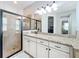 Bathroom featuring granite countertops, a glass-enclosed shower, and a vanity with ample storage space at 10319 Lavande Dr, Orlando, FL 32836