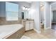 Comfortable bathroom with a large tub, separate toilet room, and a vanity with ample counter space at 10319 Lavande Dr, Orlando, FL 32836