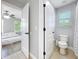 Bathroom with toilet and shower, connected to bedroom via adjoining doorway at 10319 Lavande Dr, Orlando, FL 32836