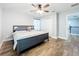 Bedroom with wood floors, ceiling fan, and a comfortable bed at 10319 Lavande Dr, Orlando, FL 32836