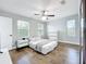 Bright bedroom with wood floors, ceiling fan, and white furniture at 10319 Lavande Dr, Orlando, FL 32836