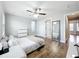 Bright bedroom with hardwood floors, ceiling fan, ensuite bathroom, and walk-in closet at 10319 Lavande Dr, Orlando, FL 32836