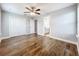 Spacious bedroom with hardwood floors, ensuite bath, ceiling fan, and double closets at 10319 Lavande Dr, Orlando, FL 32836