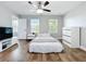 Bright bedroom with wooden floors, ceiling fan, natural light, and white decor at 10319 Lavande Dr, Orlando, FL 32836