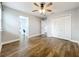Spacious bedroom with hardwood floors, ceiling fan, and double closets with built-in vanity at 10319 Lavande Dr, Orlando, FL 32836