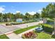 Community entrance featuring manicured landscaping, an elegant sign, and a beautiful brick paved driveway at 10319 Lavande Dr, Orlando, FL 32836