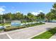 An inviting community entrance featuring lush landscaping and elegant signage at 10319 Lavande Dr, Orlando, FL 32836