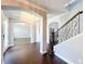 Grand entryway featuring wood floors, staircase with wrought iron railing, and arched doorways at 10319 Lavande Dr, Orlando, FL 32836