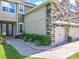 A two-story home features a three-car garage, stone accents, and fresh landscaping at 10319 Lavande Dr, Orlando, FL 32836