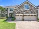 Beautiful exterior features stone accents, a tile roof, and a brick driveway at 10319 Lavande Dr, Orlando, FL 32836