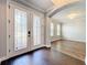 Bright entryway with decorative glass doors, wood flooring, and arched doorways at 10319 Lavande Dr, Orlando, FL 32836