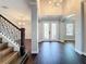 Grand foyer features wood floors, elegant staircase, and double doors at 10319 Lavande Dr, Orlando, FL 32836