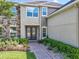Beautiful two-story home with stone accents, double door entry, and manicured landscaping at 10319 Lavande Dr, Orlando, FL 32836