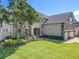 Charming home exterior with a well-manicured lawn, stone accents and lush landscaping at 10319 Lavande Dr, Orlando, FL 32836