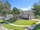 Charming two-story home with manicured lawn and decorative stone exterior at 10319 Lavande Dr, Orlando, FL 32836