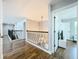 Upstairs hallway featuring wood floors and decorative wrought iron railings at 10319 Lavande Dr, Orlando, FL 32836