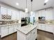 Bright kitchen with white cabinetry, granite countertops, and a center island at 10319 Lavande Dr, Orlando, FL 32836